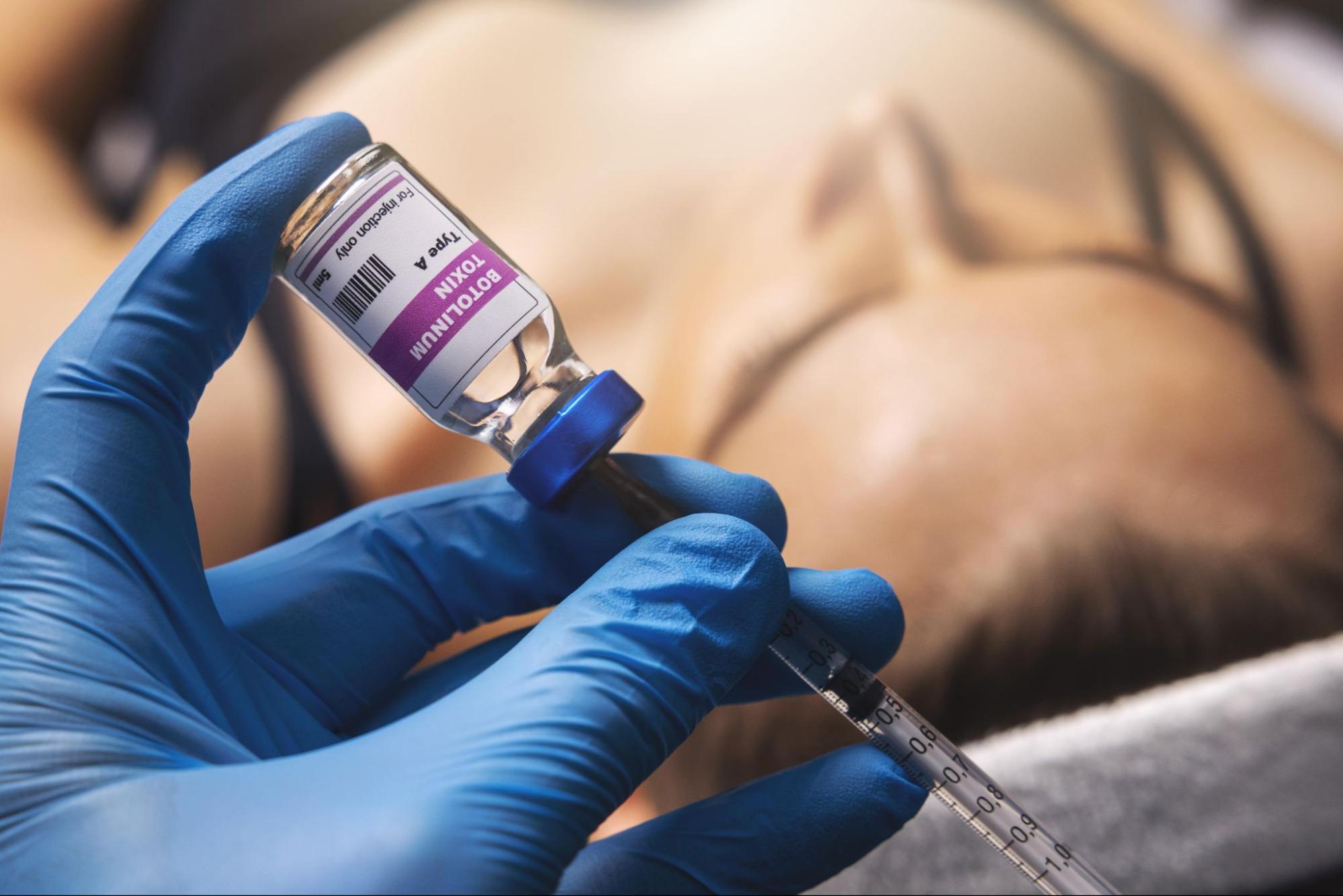 Professional administering Botox injection for facial rejuvenation and anti-aging results.