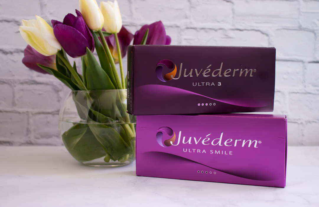 Juvederm dermal filler products displayed elegantly alongside tulips for aesthetic appeal.