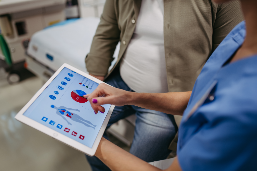 A doctor reviews health and weight metrics with a patient during a Semaglutide consultation.