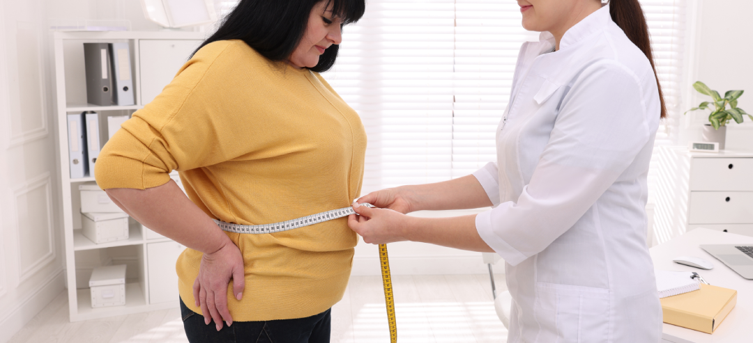 A healthcare professional measuring a patient’s waist to track weight loss progress during Semaglutide treatment.