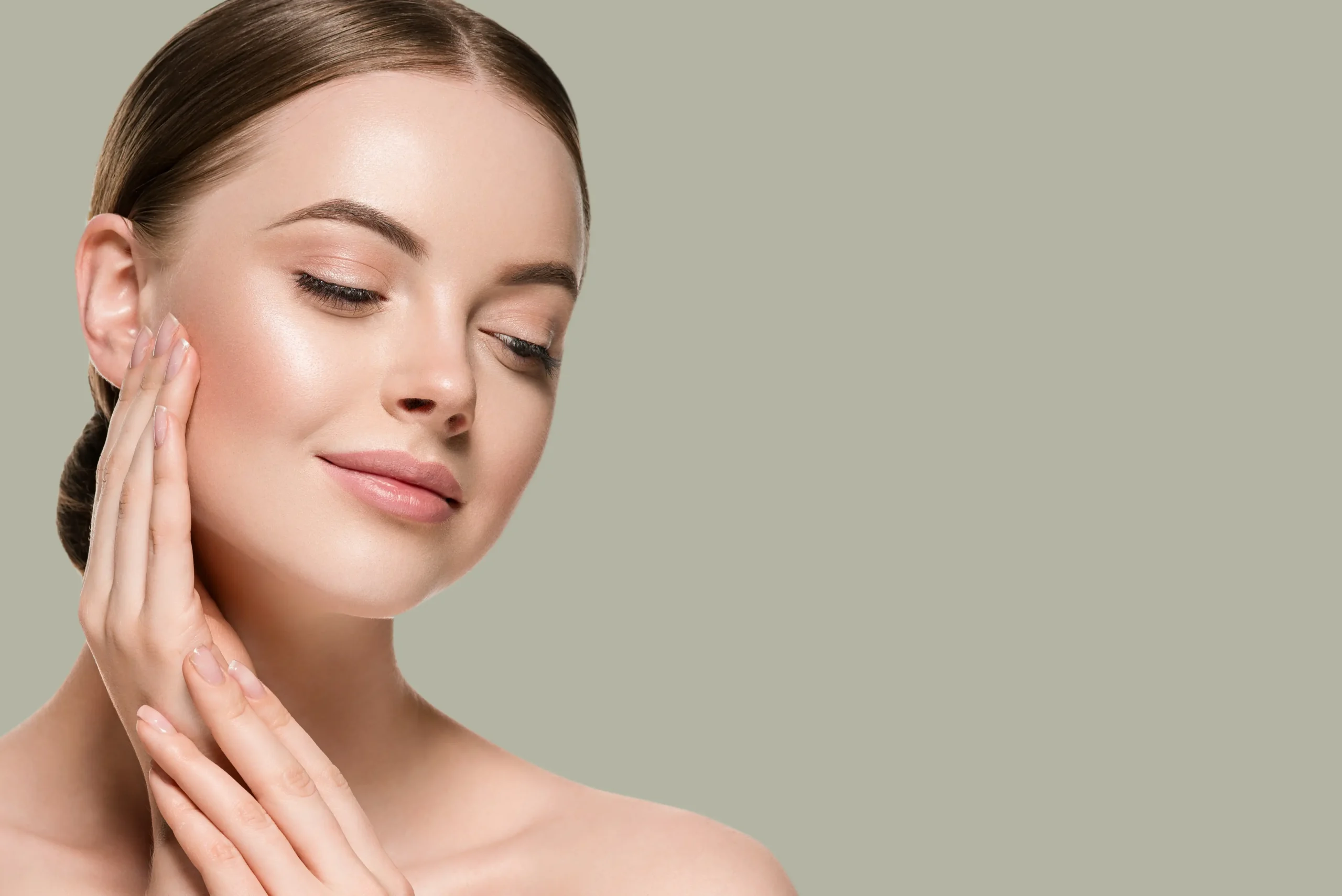 Woman with smooth skin gently touching her cheek